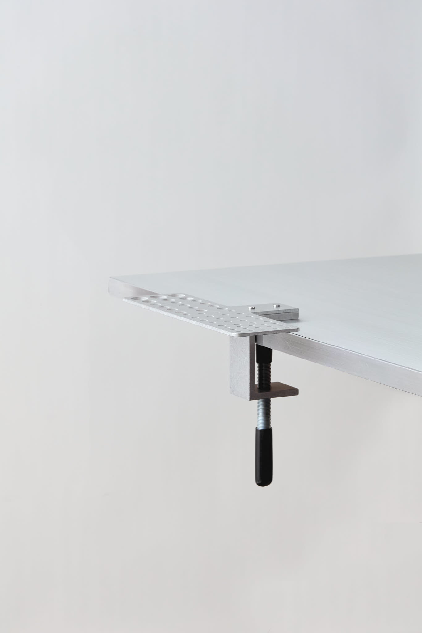 bare paintbrush holder clamped to the table